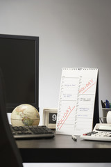 Calendar with marked holiday time on desk in office