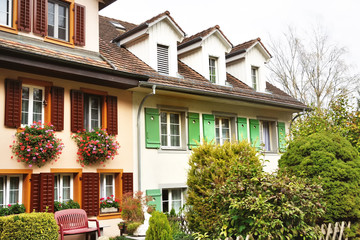 Fototapeta na wymiar Characteristic houses with flowers at the windows in Bremgarten, Switzerland