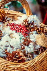closeup of beautiful basket with pine cones and viburnum
