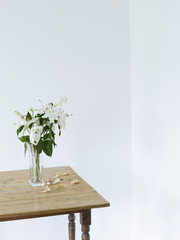White lilies in vase on table elevated view