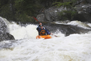 View of a man kayaking in rough river