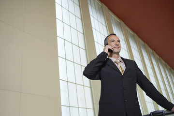 Businessman using mobile phone in the airport