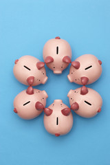 Piggy banks on blue background view from above