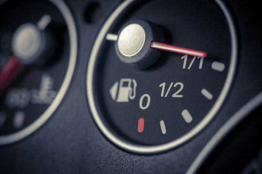 Color close up image of a car's fuel gauge.