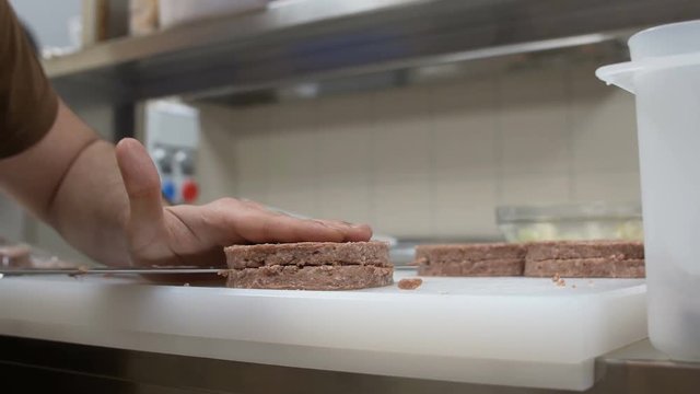 cutting hamburger in a fastfood kitchen