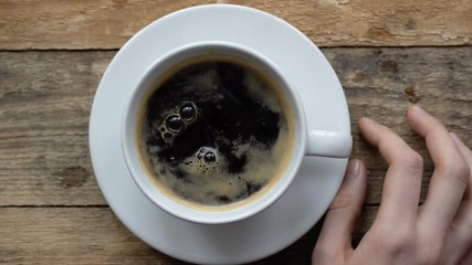 block of sugar is falling from top in coffee cup with black espresso in slow motion  - Powered by Adobe