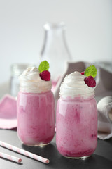 Tasty milk shake cocktails with berries on table