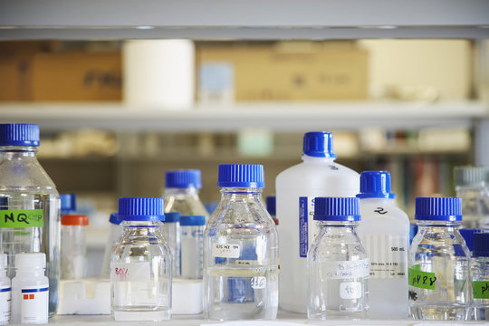 Closeup of empty chemical bottles on table in laboratory