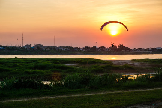 Powered parachute above the sun at sunset, Vientiane