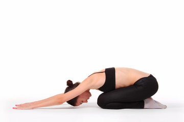 Fototapeta na wymiar young beautiful yoga posing on a studio background
