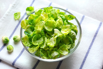 Closeup of Brussels sprouts in glass bowl on napkin