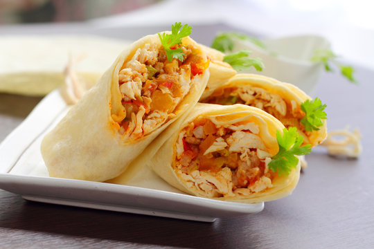 Burritos wraps with chicken and vegetables.