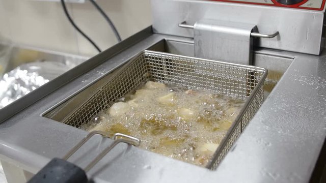 frying fish in a professional kitchen