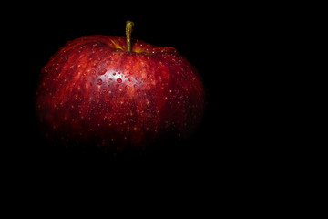 red apple on a black background