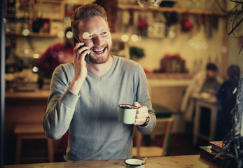 Cheerful businessman drinking coffee