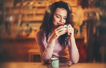 Woman enjoying aromatic coffee