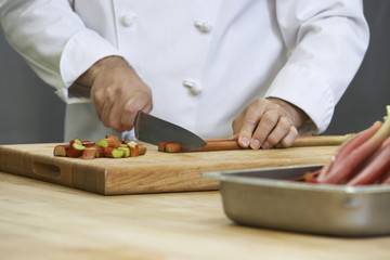 Closeup midsection of a chef chopping rhubarb