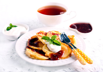 Apple fritters served with jam and yogurt