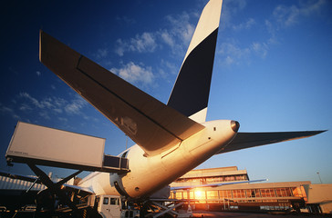 Tail fin of airplane at airport sunset © MDBPIXS