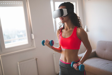 Fototapeta na wymiar Exercising at home with VR glasses