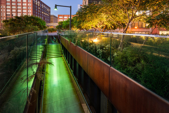 The High Line promenade illuminated at twilight in the West Village. The aerial greenway is also known as Highline or High Line Park. Manhattan, New York CIty