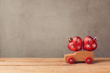 Christmas holiday concept with toy car and decorations over rustic background