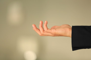 Male hand holding something on blurred background