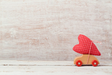 Valentine's day concept with toy car and heart shape