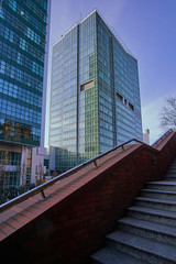 Stone staircase and modern office buildings in the city center to Poznan.