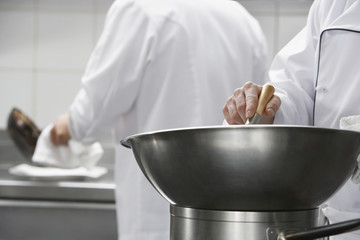 Closeup of a chef mixing ingredients in a bowl
