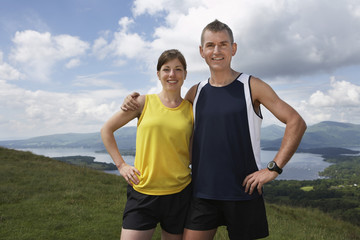 Portrait of a smiling couple standing on country landscape