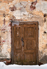 vintage wooden door. The old building. Background, surface destroyed by time and weather. Detail of the exterior