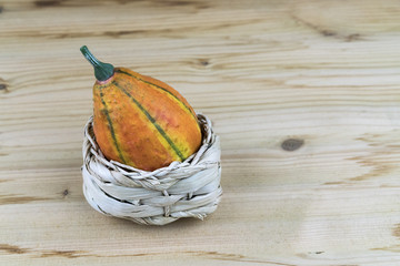 Ornamental gourd in a white wicker basket