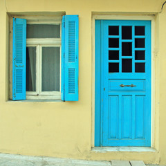 Blue greek shutters window and door in old house