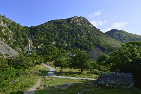 Wide landscape with Tropical waterfall and pathway leading to it on summers day, Aber falls abergwyngregyn wales