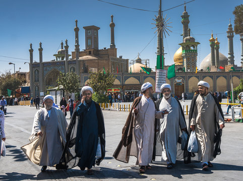 Chatting mullahs against the minarets of the Hazrat-e Masumeh (Holy Shrine), Qom, Iran