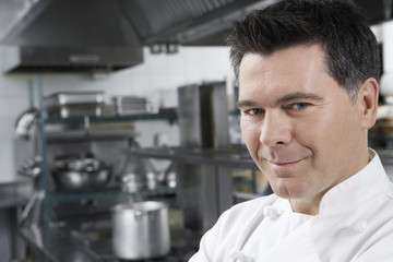 Closeup portrait of a smiling male chef in the kitchen