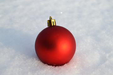 red Christmas ball on white snow

