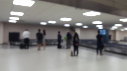 Blurry abstract Travelers waiting for their luggage at the bagga