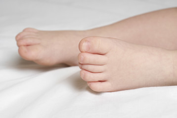 Closeup of baby's feet on bed