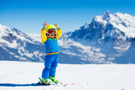 Ski and snow fun for child in winter mountains
