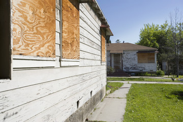 Exterior of an abandoned house with boarded up windows