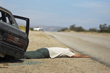 Victim of car accident lying on roadside