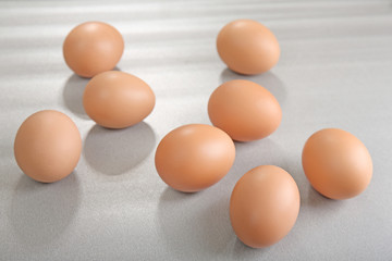 Raw eggs on grey background