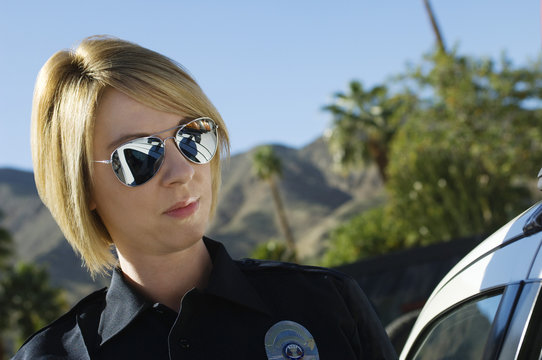 Closeup Of Beautiful Female Police Officer Wearing Sunglasses