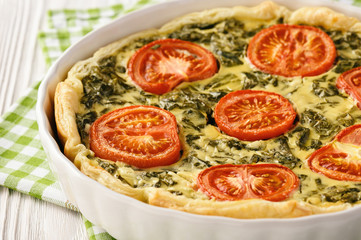 Homemade quiche with spinach, feta cheese and tomatoes.