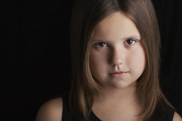 Fototapeta premium Closeup portrait of cute little girl against black background