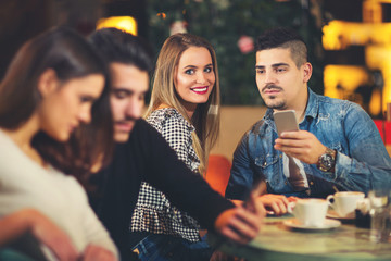 Group of young people meeting in a cafe.