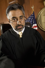 Portrait of a judge wearing glasses in the courtroom