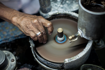  Polishing moonstone at the factory for the extraction and processing of precious stones. Soft selective focus.
